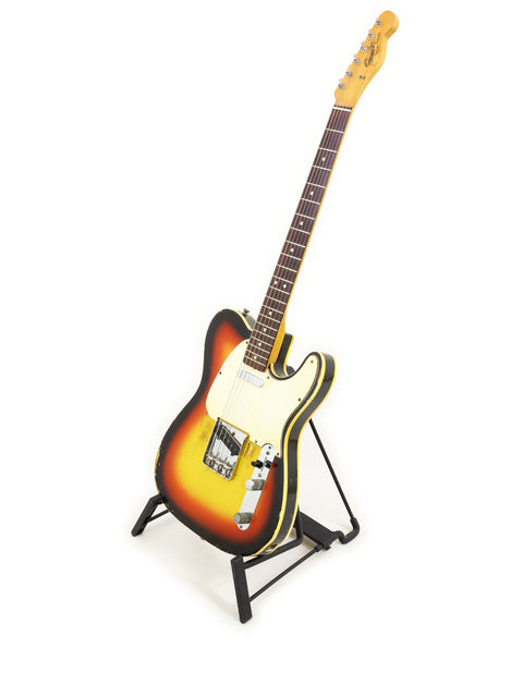 Vintage Fender Custom Telecaster from 1966 elegantly positioned on a stand with a simple white background.
