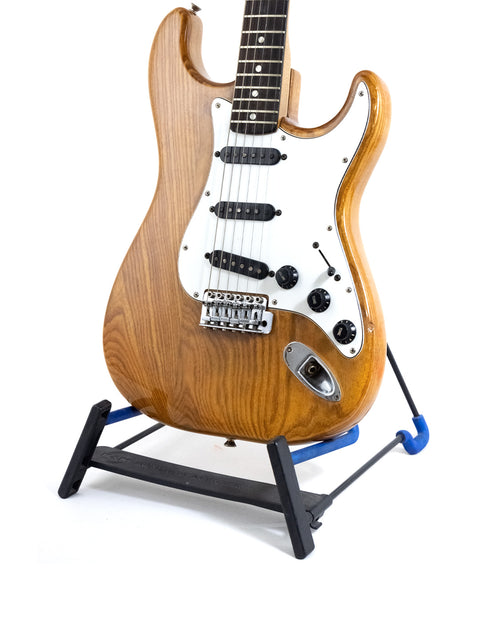 Vintage Fender Stratocaster from 1979 resting on a black stand, emphasizing its iconic shape and style.