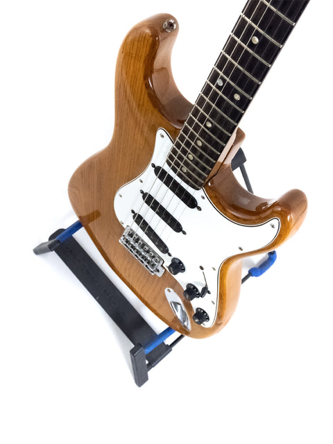 Vintage Fender Stratocaster from 1979 resting on a blue stand, emphasizing its iconic style and history.