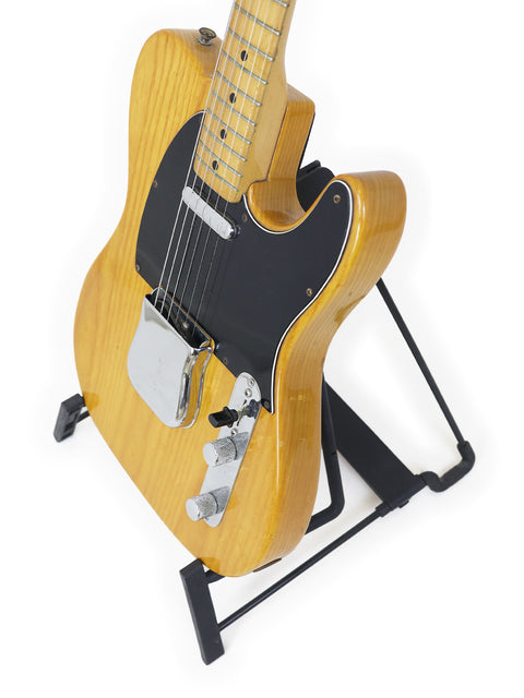  Vintage Fender Telecaster from 1977-78 resting on a black stand, emphasizing its timeless appeal and design.