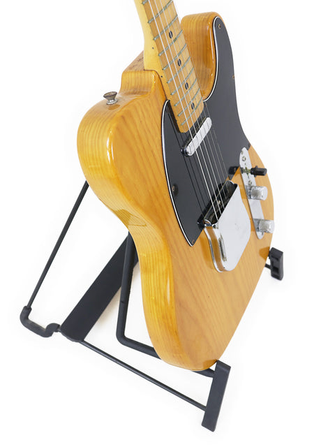 Vintage Fender Telecaster from 1977-78 resting on a black stand, emphasizing its timeless style and quality.