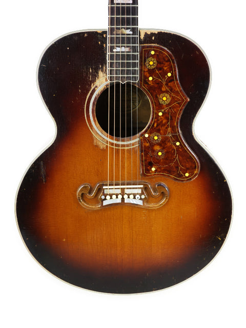 Vintage Gibson J-200 acoustic guitar with a sunburst finish, crafted in the USA in 1954, showcasing classic design and craftsmanship.