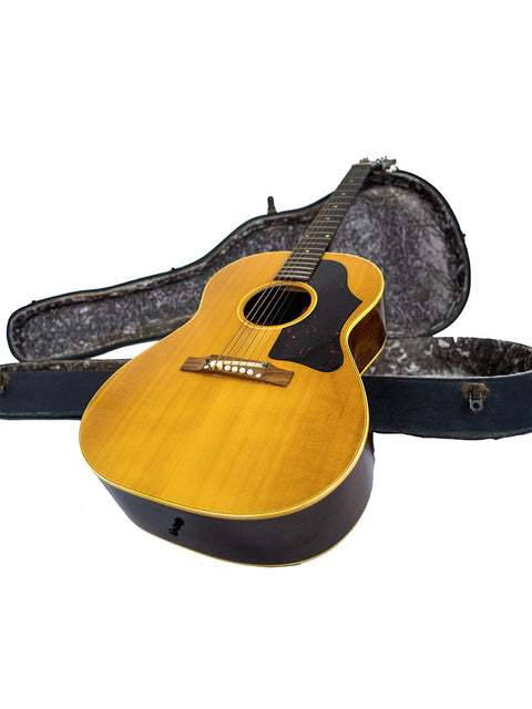  Vintage Gibson LG-3 Acoustic guitar from 1962 alongside its case on a white surface.