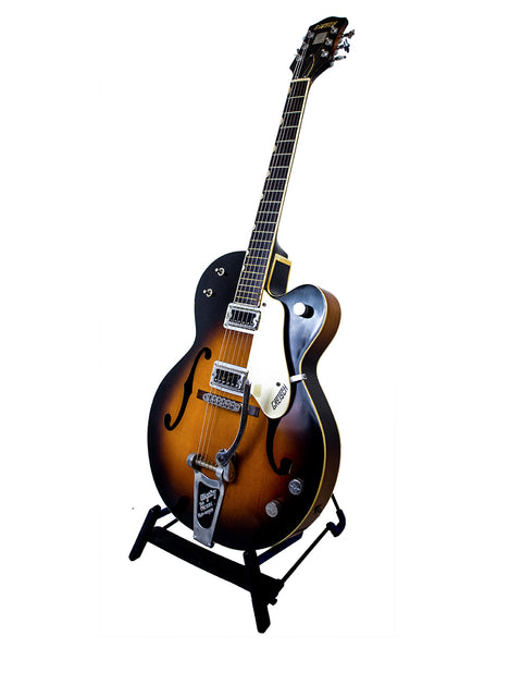 Vintage Gretsch Double Anniversary 6117 guitar from 1964 displayed on a stand, capturing its iconic style and history.