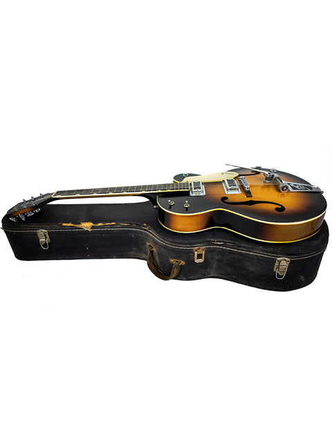 Vintage Gretsch Double Anniversary 6117 guitar resting in a case, set on a white background, highlighting its 1964 craftsmanship.