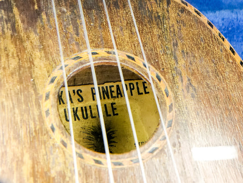 Vintage Kamaka ukulele from 1930, featuring a pineapple label, a beautiful representation of Hawaiian musical tradition.