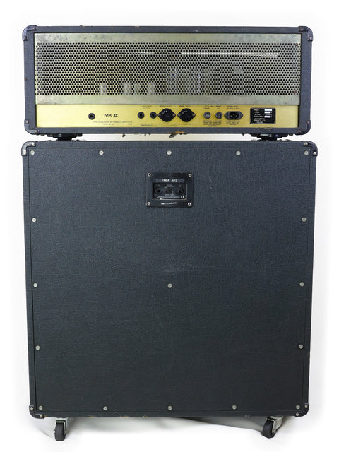 Vintage black and gold Marshall JCM800 head with gold accents, alongside a 1960A lead cabinet, showcasing classic 1983 design.