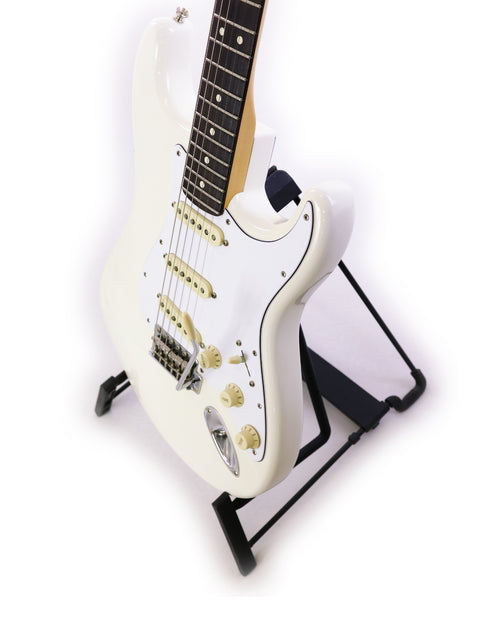 White electric guitar on stand, isolated on a white background.