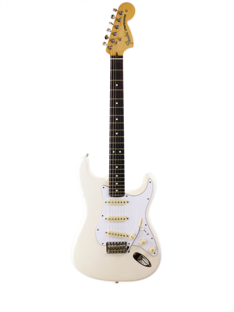 White electric guitar with a black fretboard on a white background.