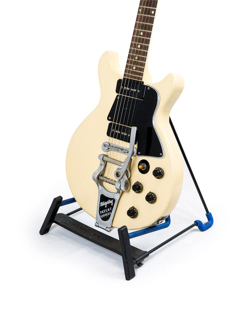 White vintage Gibson Les Paul Special Refin guitar from 1959, displayed on a blue stand.