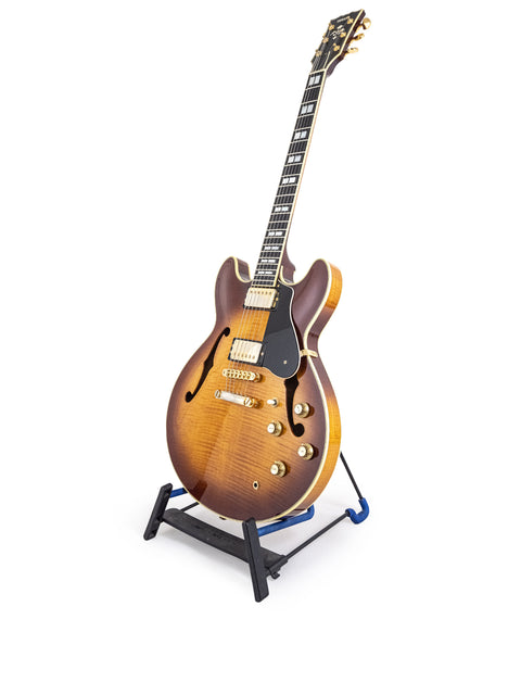 Yamaha SA 2200 Thinline guitar displayed on a stand with a bright white backdrop