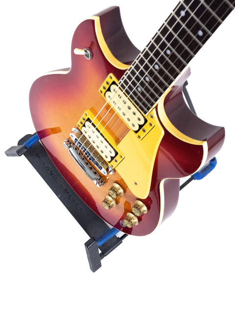 Yamaha SG 800S guitar from 1981 resting on a blue stand, blending vintage charm with modern display.