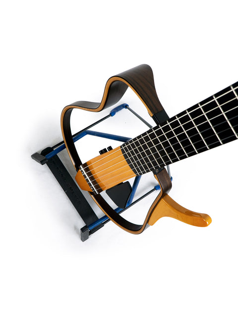 Yamaha SLG 120NW Silent Guitar, Japan 2009, displayed on a stand, showcasing its strings.