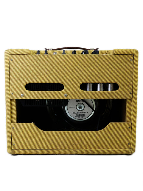 Yellow Fender EC Tremolux Combo Amplifier with a sleek black cover, highlighting its distinctive style from 2014, USA.
