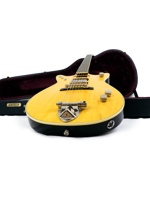 Yellow Gretsch G6131 Malcolm Young Signature Jet guitar with a case, displayed on a bright white background.