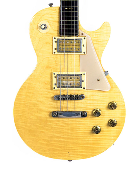 Yellow Univox Gimmie U-1988 electric guitar displayed against a clean white background, showcasing its vintage design.
