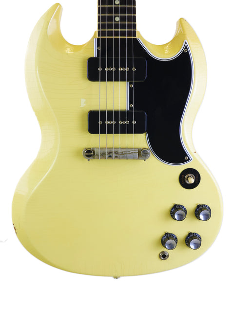 Yellow electric guitar, Gibson Custom ‘63 SG Special, featuring a black pickup, highlighting its unique style and craftsmanship.