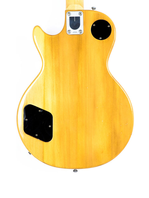 Yellow electric guitar, Univox Gimmie U-1988, Japan, 1974-75, with distinctive black buttons for enhanced functionality.
