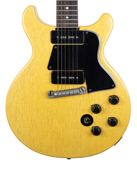 Yellow electric guitar, a 1958 Gibson Les Paul Special, featuring a black pickup, exemplifying vintage craftsmanship.
