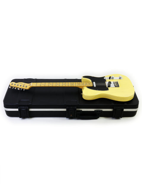 Yellow electric guitar lying in an open black hard case on a white background.