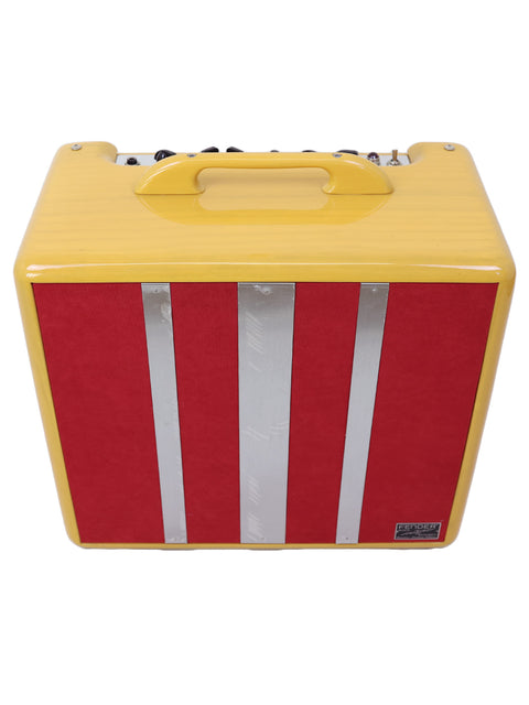 Yellow guitar amplifier with red and silver stripes front view.