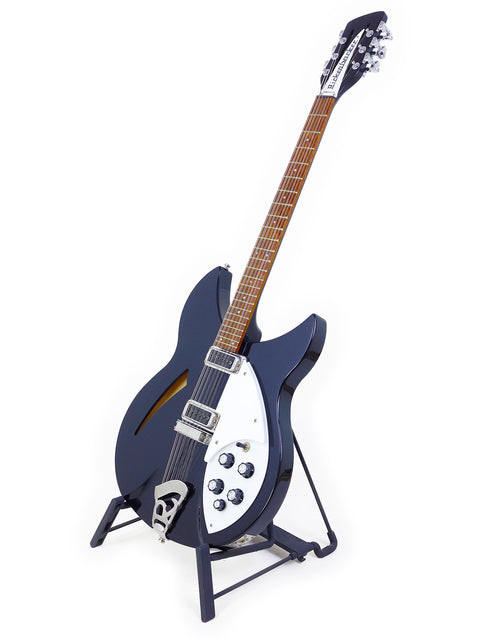 black Rickenbacker 330 12-string guitar adorned with a white pick guard, exemplifying a perfect blend of elegance and sound.
