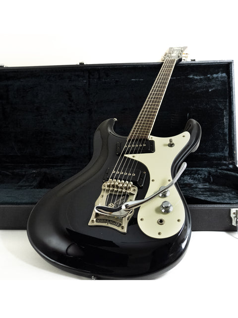 black electric guitar inside a protective case, identified as the Mosrite Of California – The Ventures Model from the 1990s.