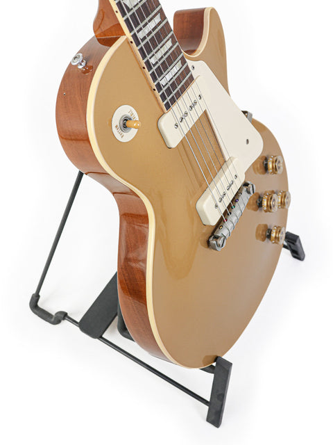 gold Gibson Les Paul LPR-4 1954 Reissue electric guitar elegantly displayed on a stand.