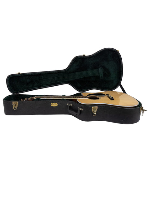 open wooden guitar case revealing a Martin DC Aura GT Dreadnought guitar, highlighting its beauty and quality from 2019.