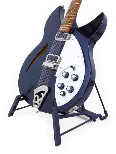 striking black Rickenbacker 330 12-string guitar with a white pick guard, highlighting its elegant and classic appearance.