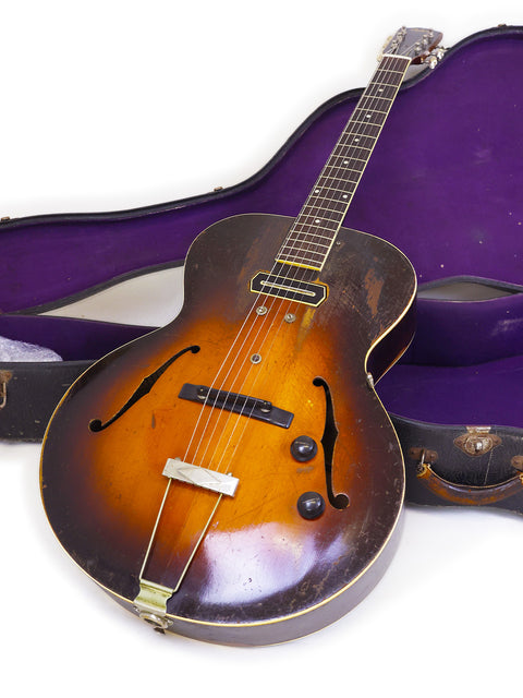 vintage Gibson ES-150 guitar from 1938, elegantly placed in its protective case, reflecting musical heritage.