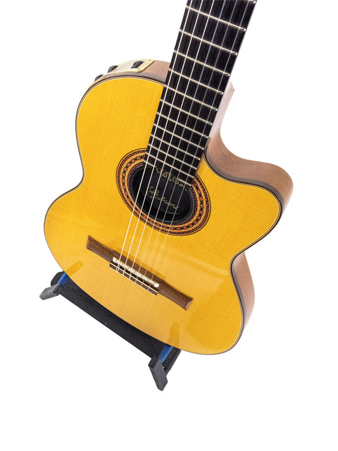 yellow acoustic guitar elegantly positioned on a stand, identified as the Gibson Chet Atkins CEC from 2001, USA.